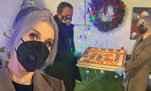 Kelly Osbourne gives Jeff Beacher a cake to celebrate Airbnb IPO